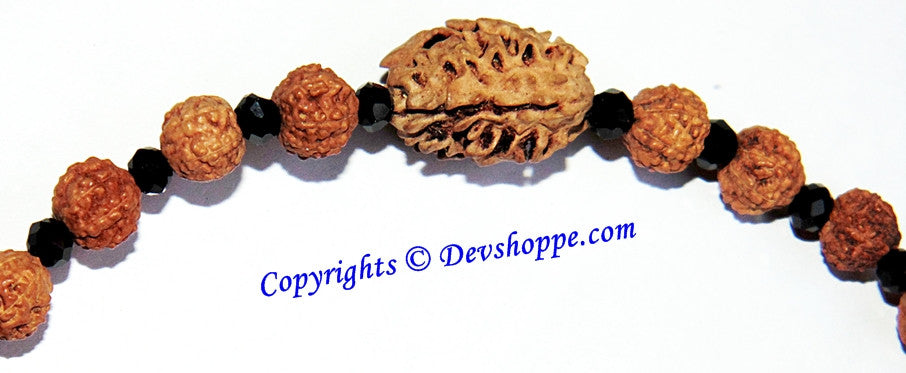 Textured 7-mukhi Rudraksha bracelet bead with red-brown seed beads and black spacers