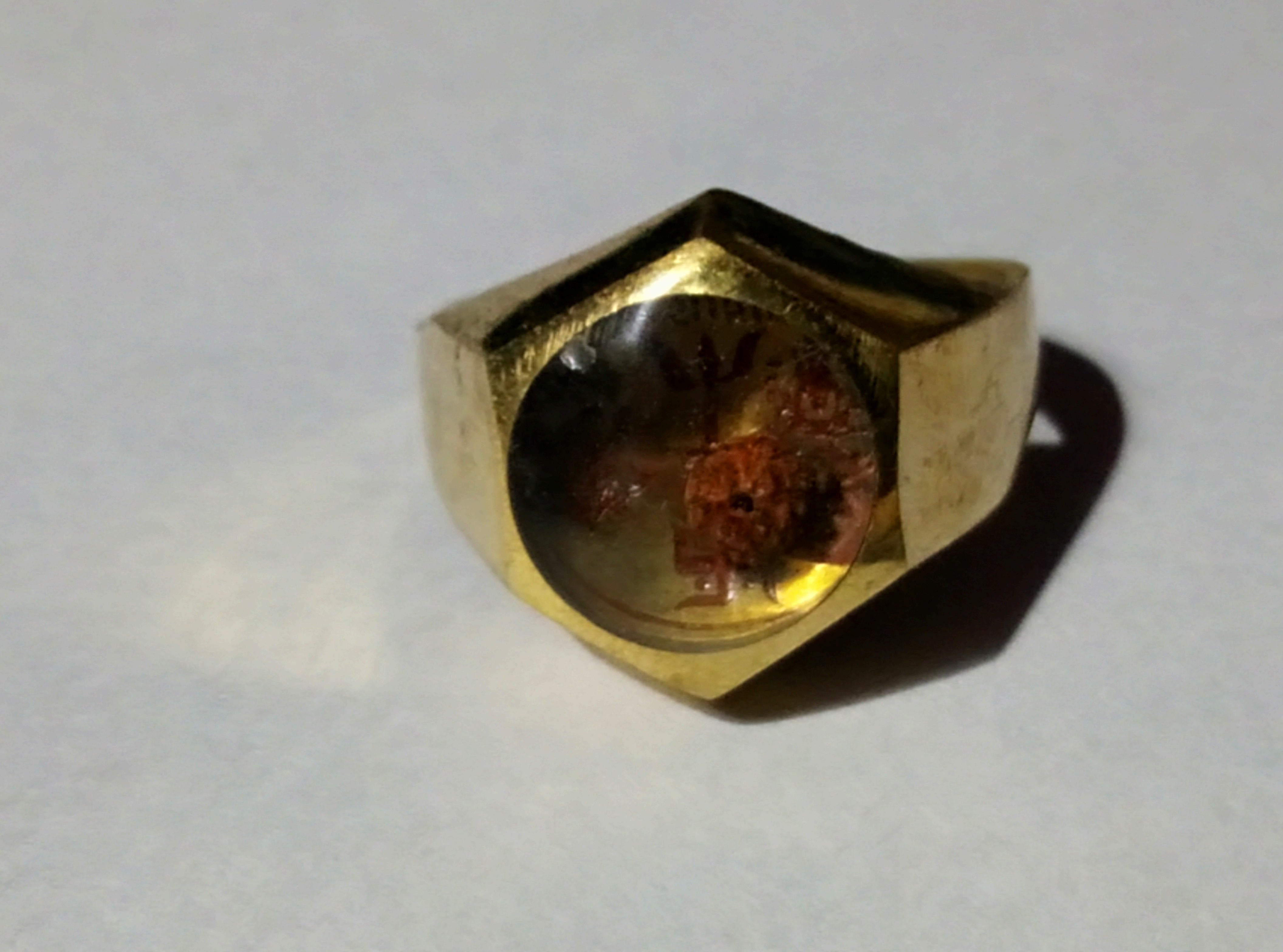 Brass Lakshmi Ganesha ring, open top view of dark Rudraksha inset