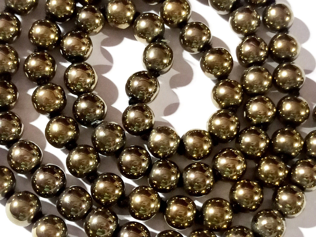 Golden pyrite mala with round metallic-gold beads and dark tassel