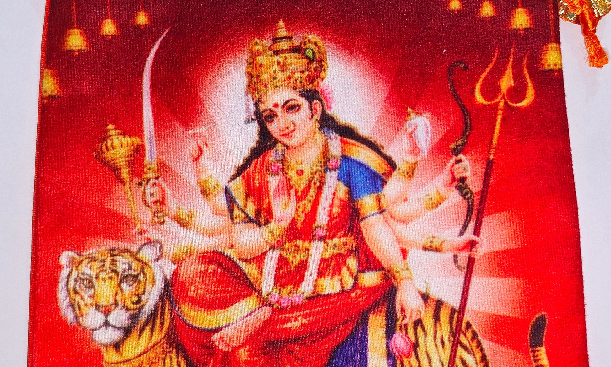 Close-up of Maa Vaishno Devi (Durga) design on the orange pouch bag front