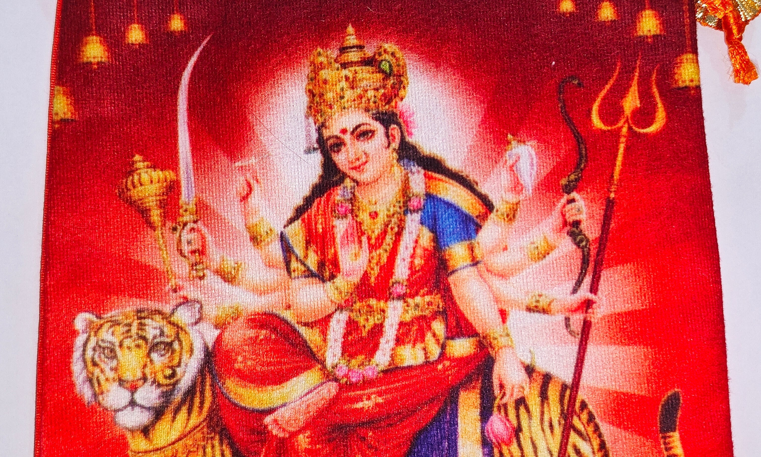 Close-up of Maa Vaishno Devi (Durga) design on the orange pouch bag front