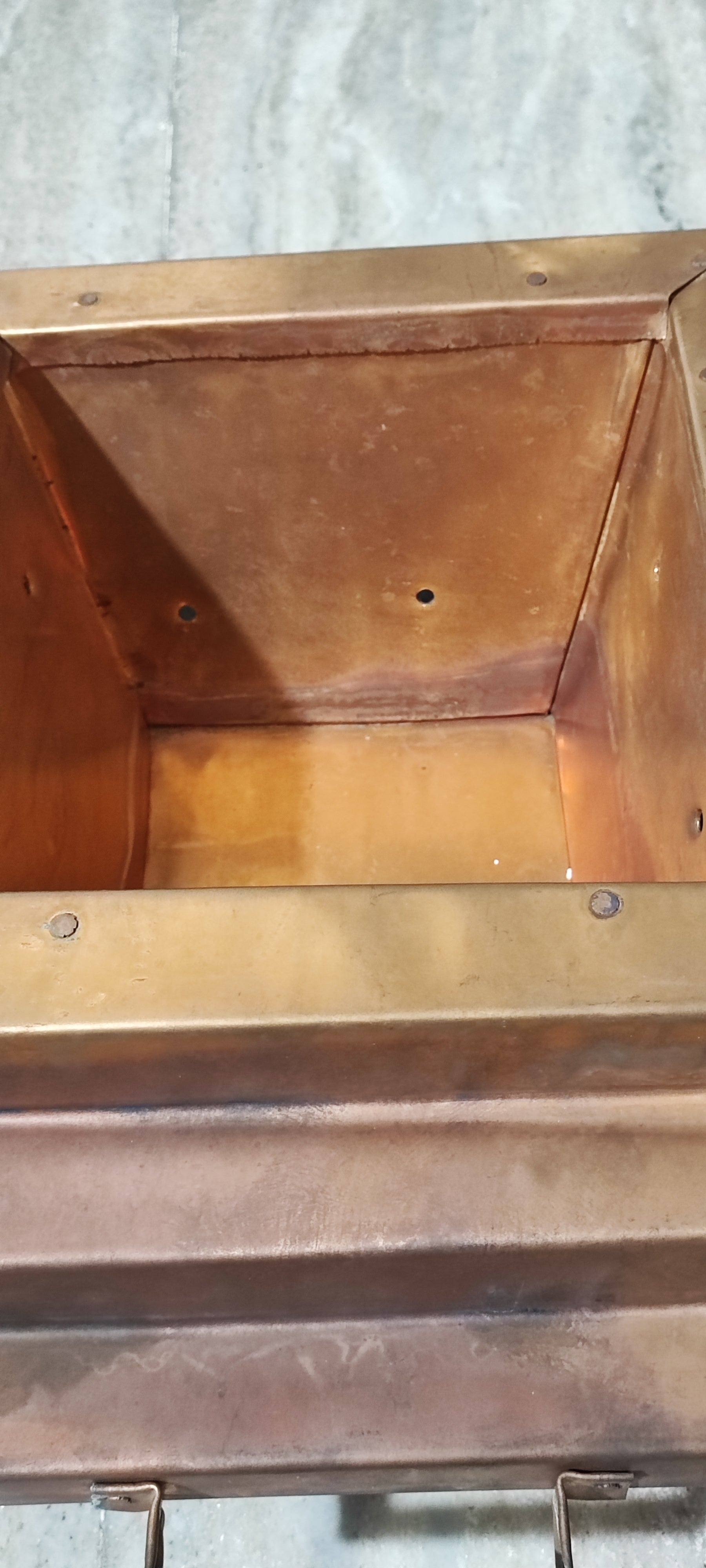 Copper havankunda interior close-up with stepped rim and riveted corner points