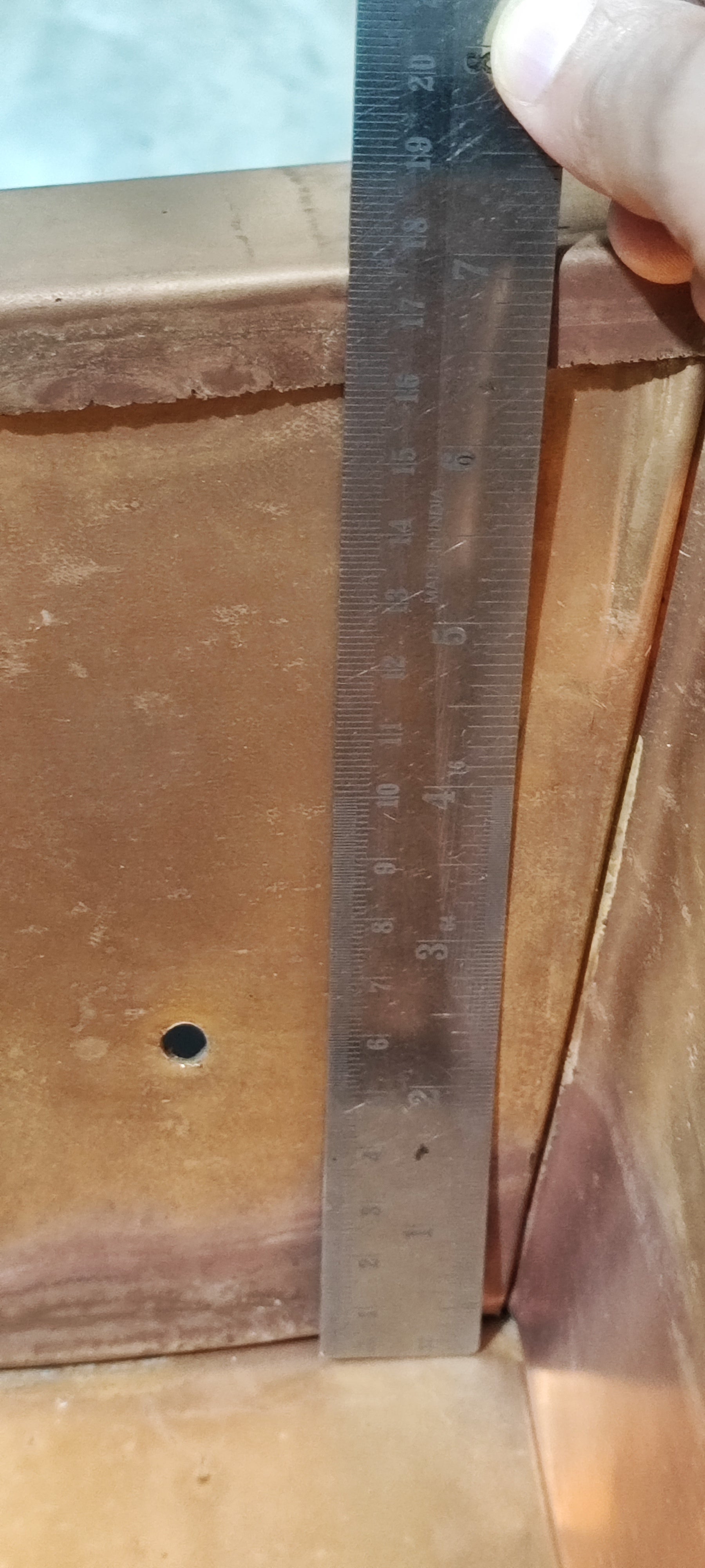 Ruler measuring height on the copper havankunda side panel, close-up