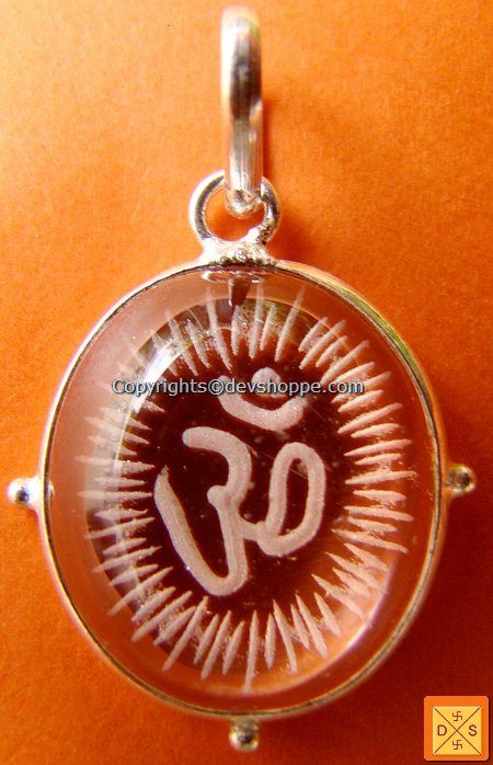 Om crystal pendant with amber cabochon and white-metal circular bezel