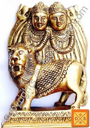 Brass Chamunda idol with lion figure and twin goddess faces, gold-tone