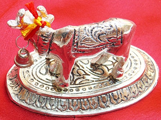 White cow and calf idol, flower ornament on horns and engraved circular platform