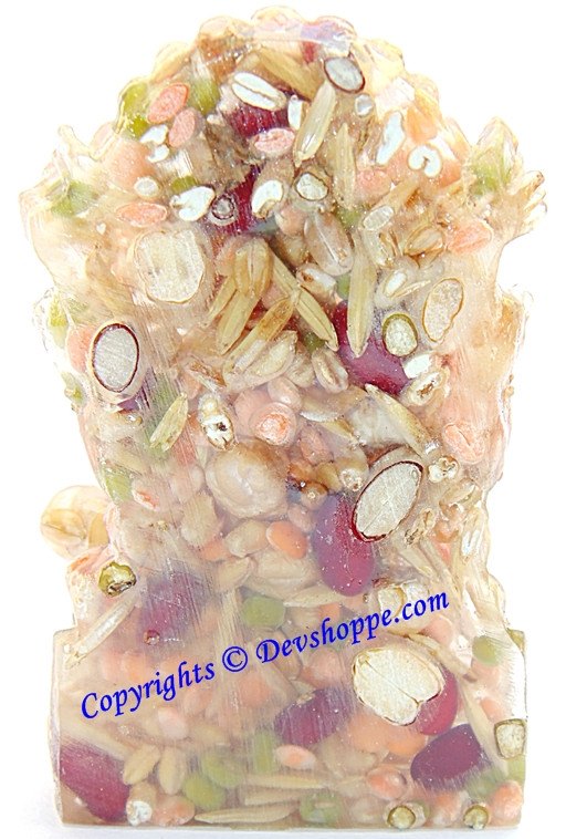 Ganesha idol figurine with colorful stones and ornate carvings, detailed view
