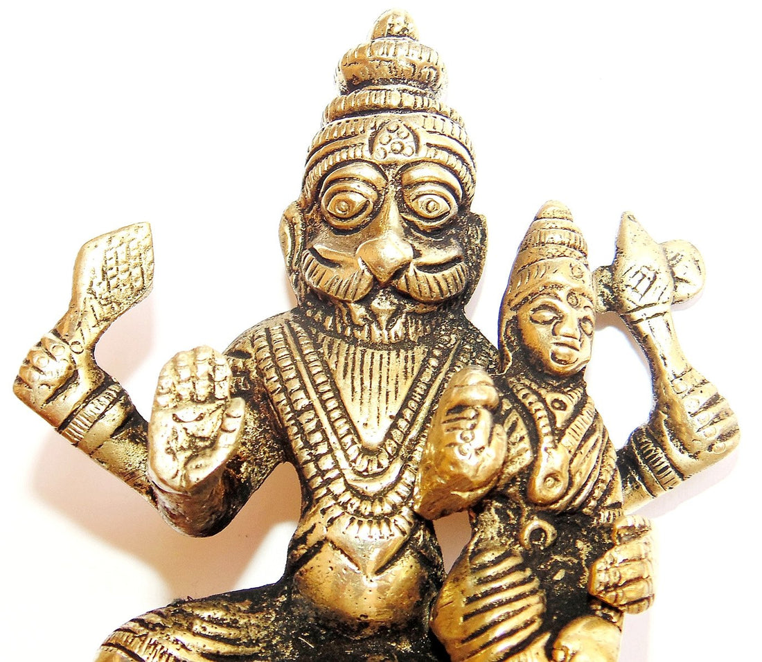 Panchdhatu idol of seated Sri Lakshmi Narasimha with raised arms, detailed face