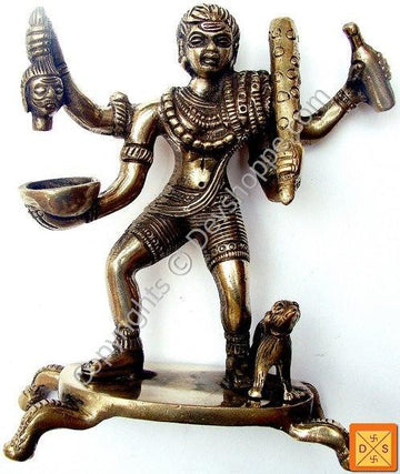 Sri Kal Bhairav idol in bronze tone, four-armed standing posture with trident-like weapon.