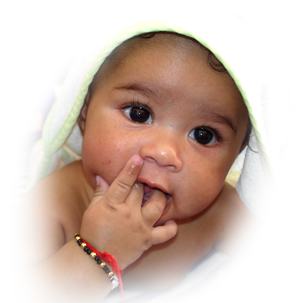 Baby wearing black-and-gold bead bracelet with a red tassel on the wrist