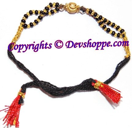 Black bead children’s bracelet with gold center charm and red tassel ties