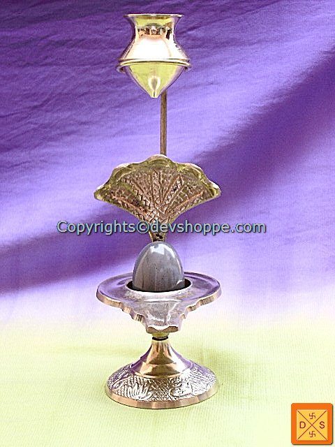 Ceremonial offering stand with tall stem, ornate finial and round base