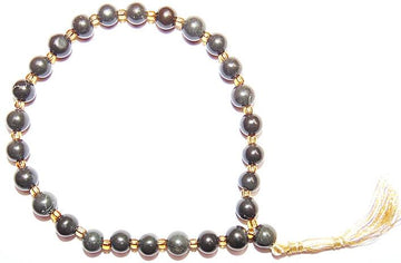 Black Hakik wrist mala bracelet with gold spacers and small tassel