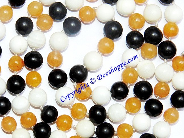 Close-up hakik mala beads: white, yellow and black agate spheres