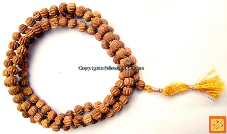 Sandalwood mala bracelet with round carved beads and yellow tassel