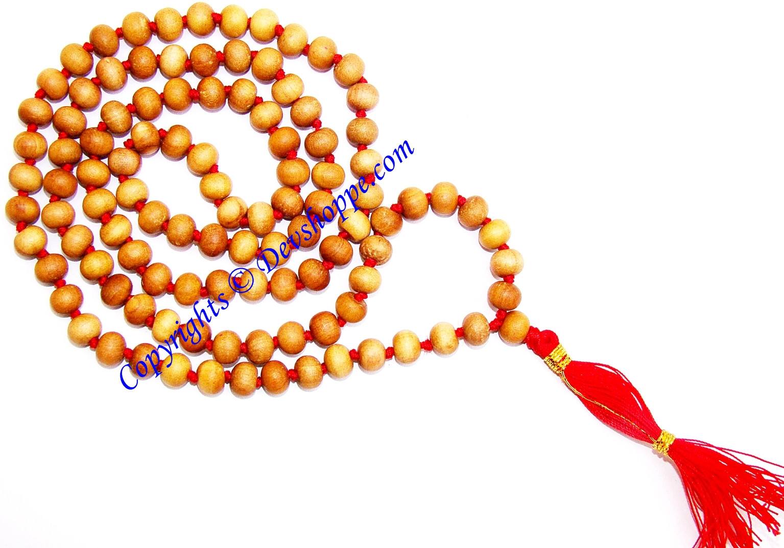 Sandalwood mala necklace with round wooden beads and red tassel