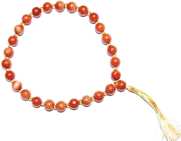 Sunstone goldstone wrist mala with orange glitter beads and gold tassel, 27+1