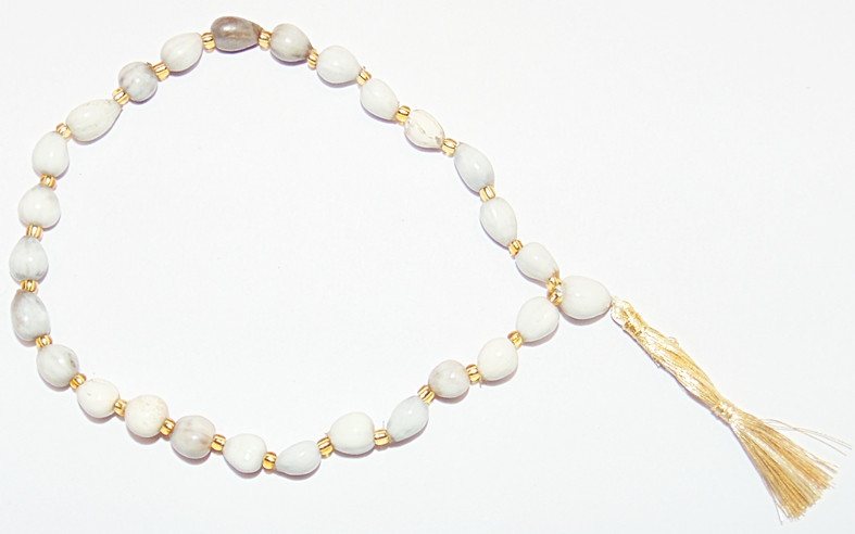 Vaijanti wrist mala: opalescent white beads with gold spacers and gold tassel