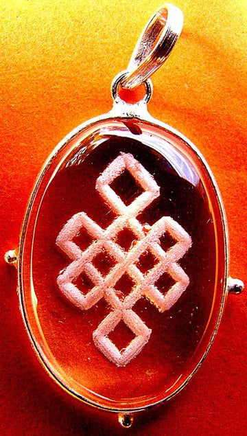 Mystic knot crystal pendant: oval dark red stone with silver frame and bail