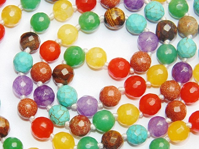 Close-up of multicolor round gemstone beads on a mala necklace strand