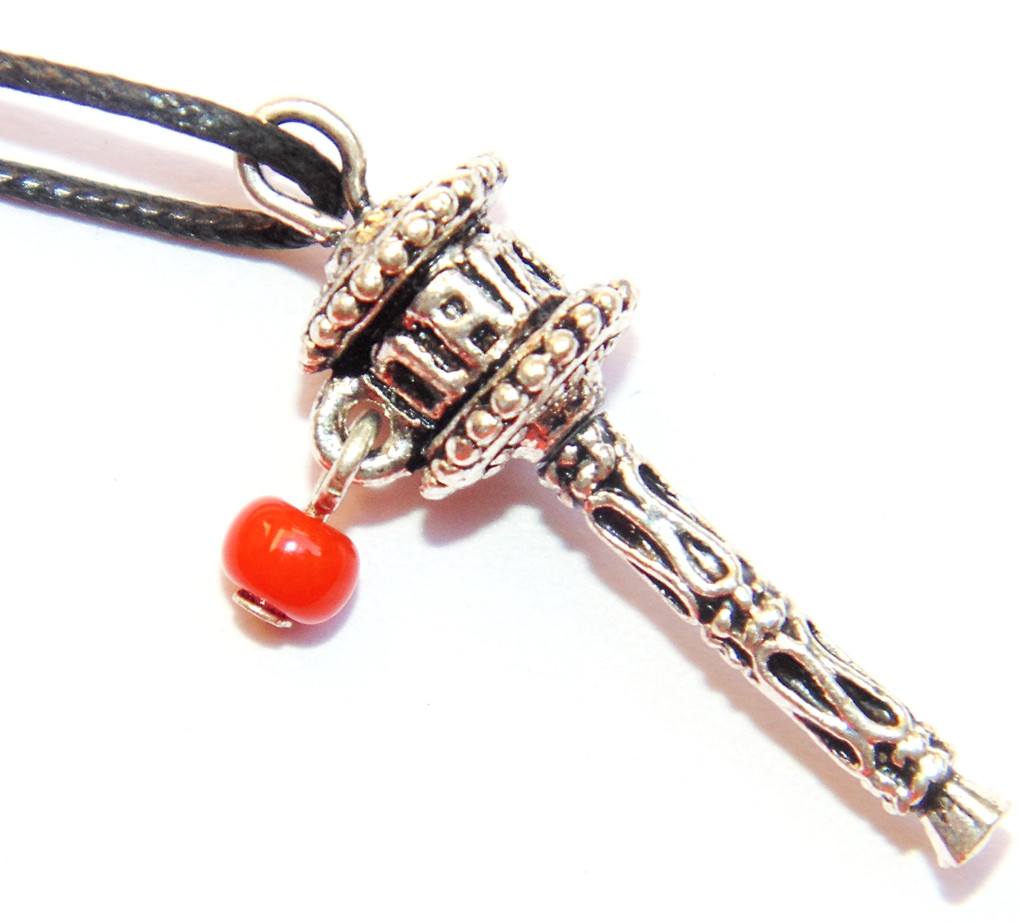 Dharma prayer wheel pendant with red bead, ornate metal wrap on leather cord