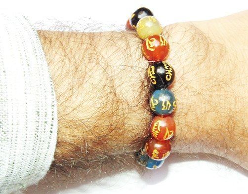Multicolored agate bead bracelet with carved Om Mani Padme Hum mantra symbols
