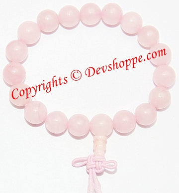 Rose quartz power bracelet with round pale pink beads and tied cord closure