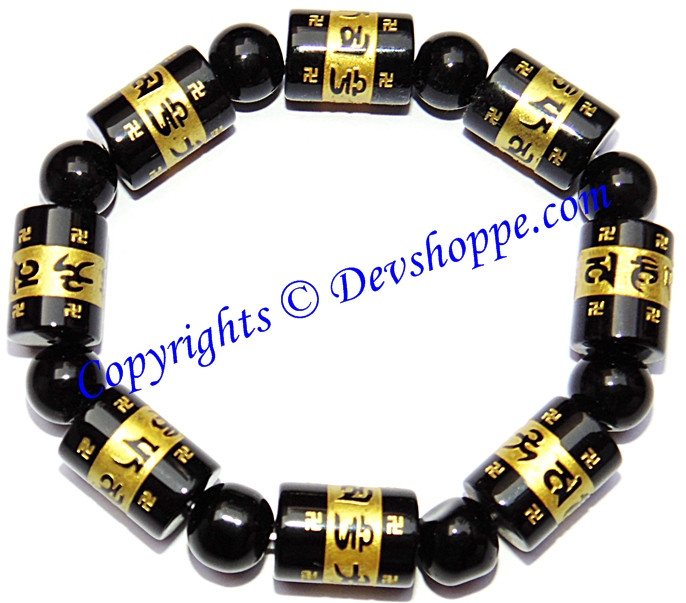 Black agate bead bracelet with carved mantra Aum mani padme hum on gold-toned tubes