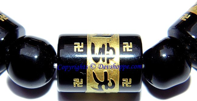 Black agate bead bracelet with carved mantra Aum mani padme hum on gold-toned tubes