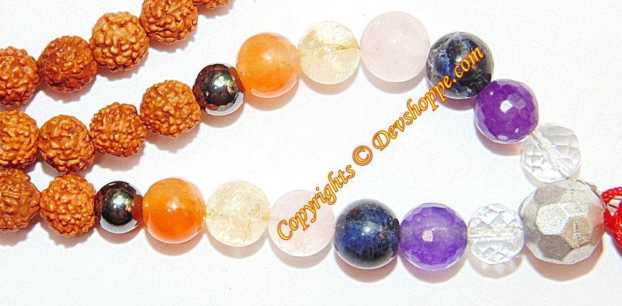 Multi-colored mala beads: orange, purple, white, dark stones, and silver-textured beads