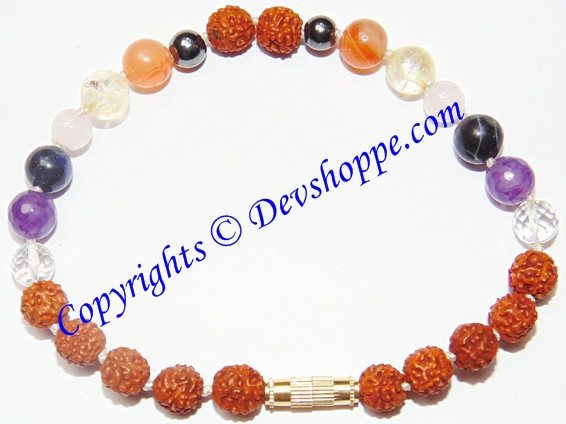 Handcrafted bracelet with orange, purple, black, and clear multi-stone beads and gold centerpiece
