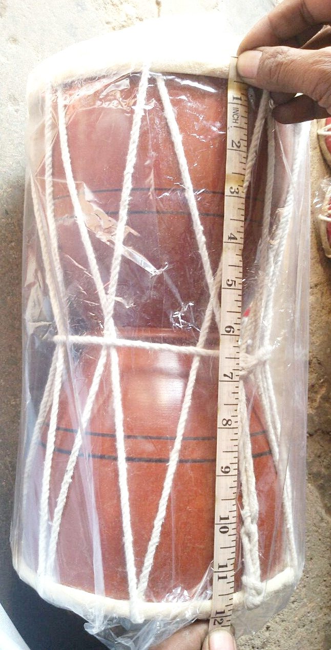 Jumbo 12-inch wooden damru length measurement shown next to tied crisscross lacing