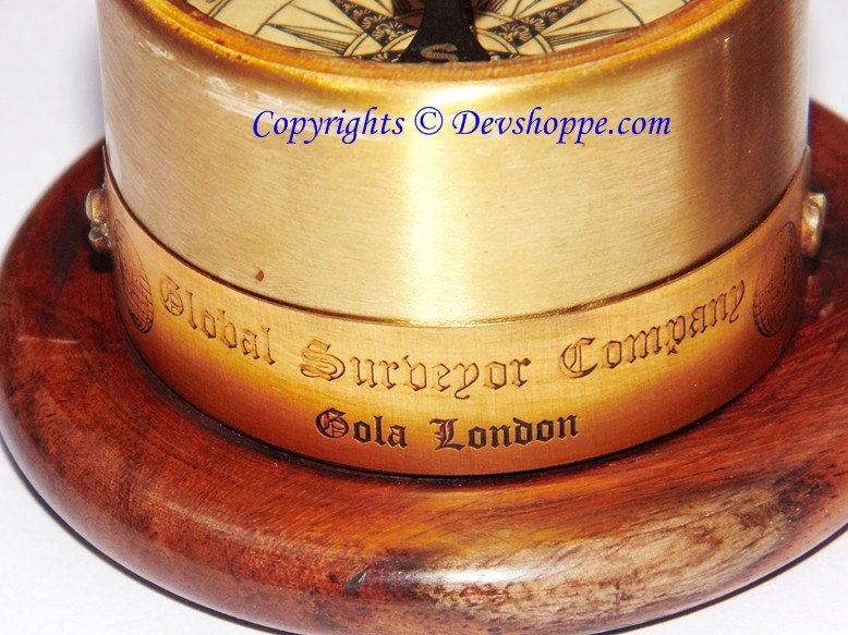 Wooden compass side with engraved text and brass-toned top ring