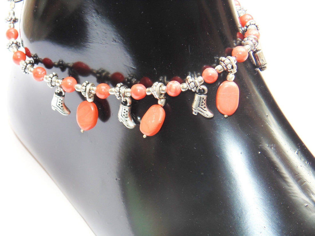 Traditional beaded anklet with orange coral beads and silver-tone charm dangles