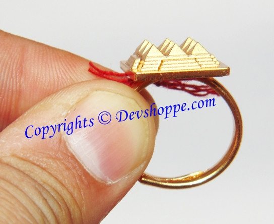 Brass pyramid ring side view with red thread tassel and gold-tone cap