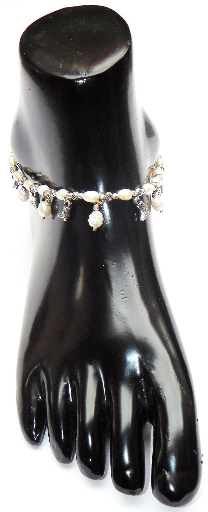Pearl anklet featuring multiple charms and pearl beads wrapped around ankle