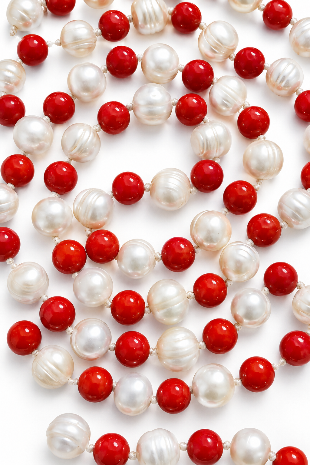 Pearl and coral mala beads close-up with white pearls and red coral beads