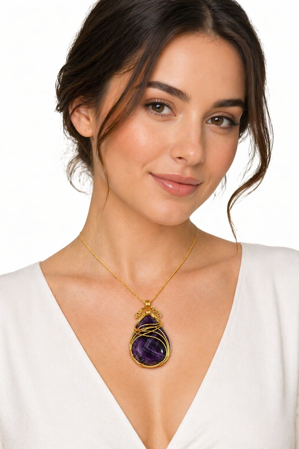 Gold-tone amethyst pendant necklace with teardrop purple gemstone, on a model