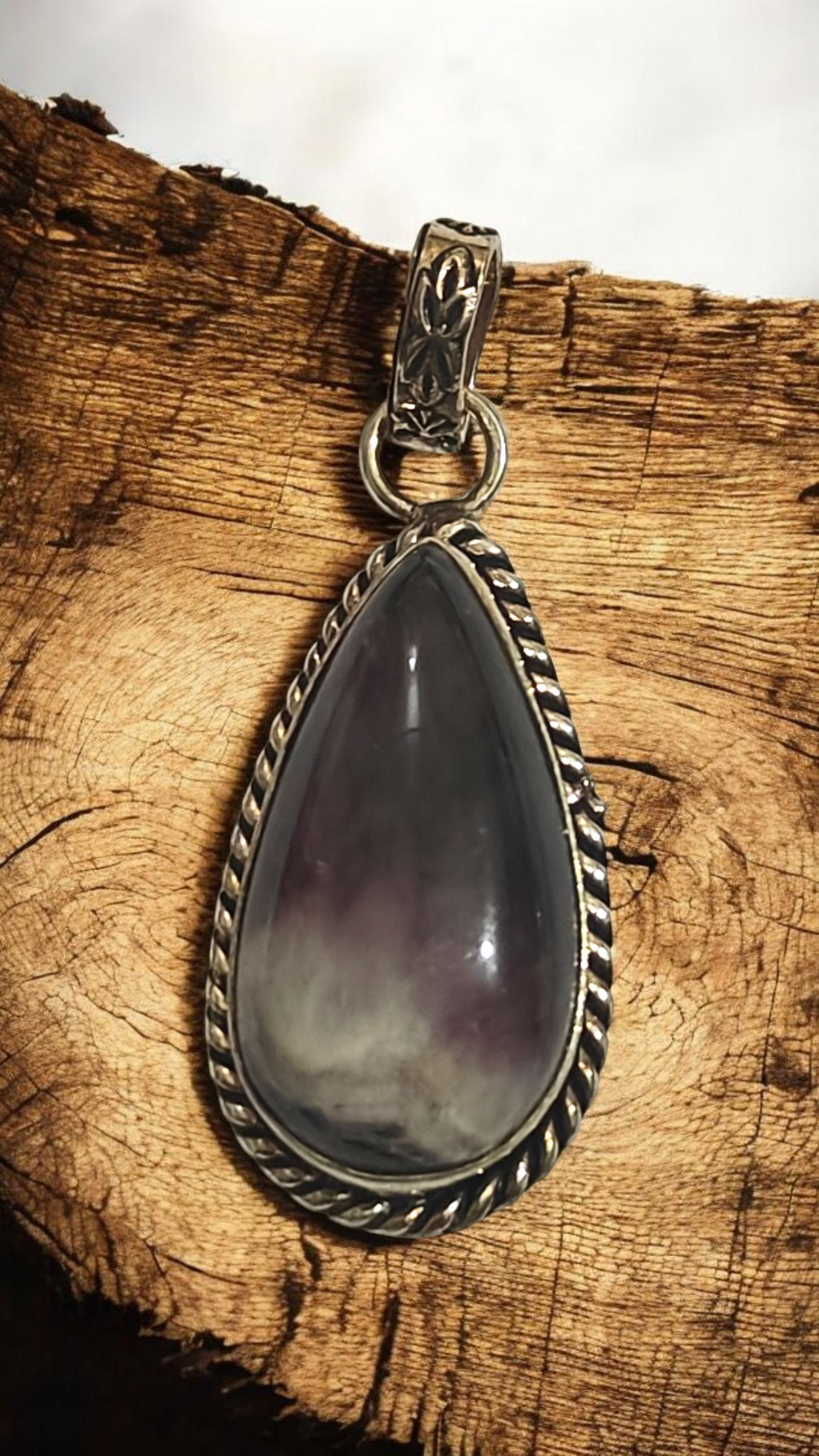 Natural amethyst teardrop pendant with silver-tone bezel and loop bail