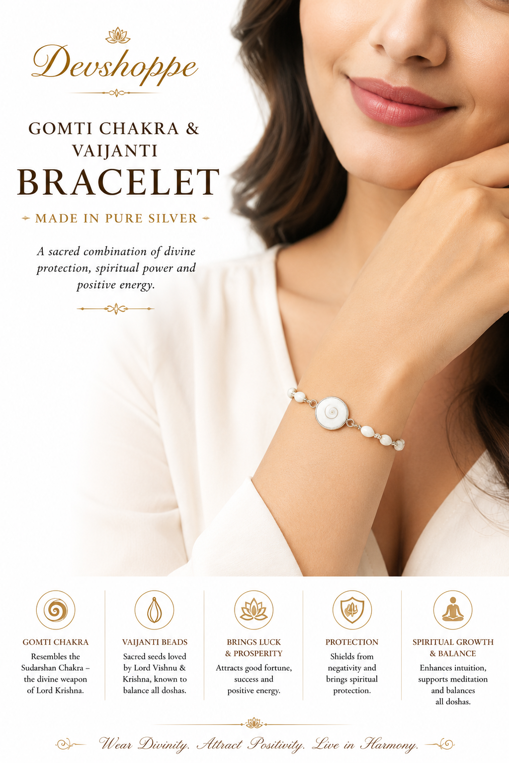 Bracelet on wrist with white beads and silver circular Gomti chakra pendant