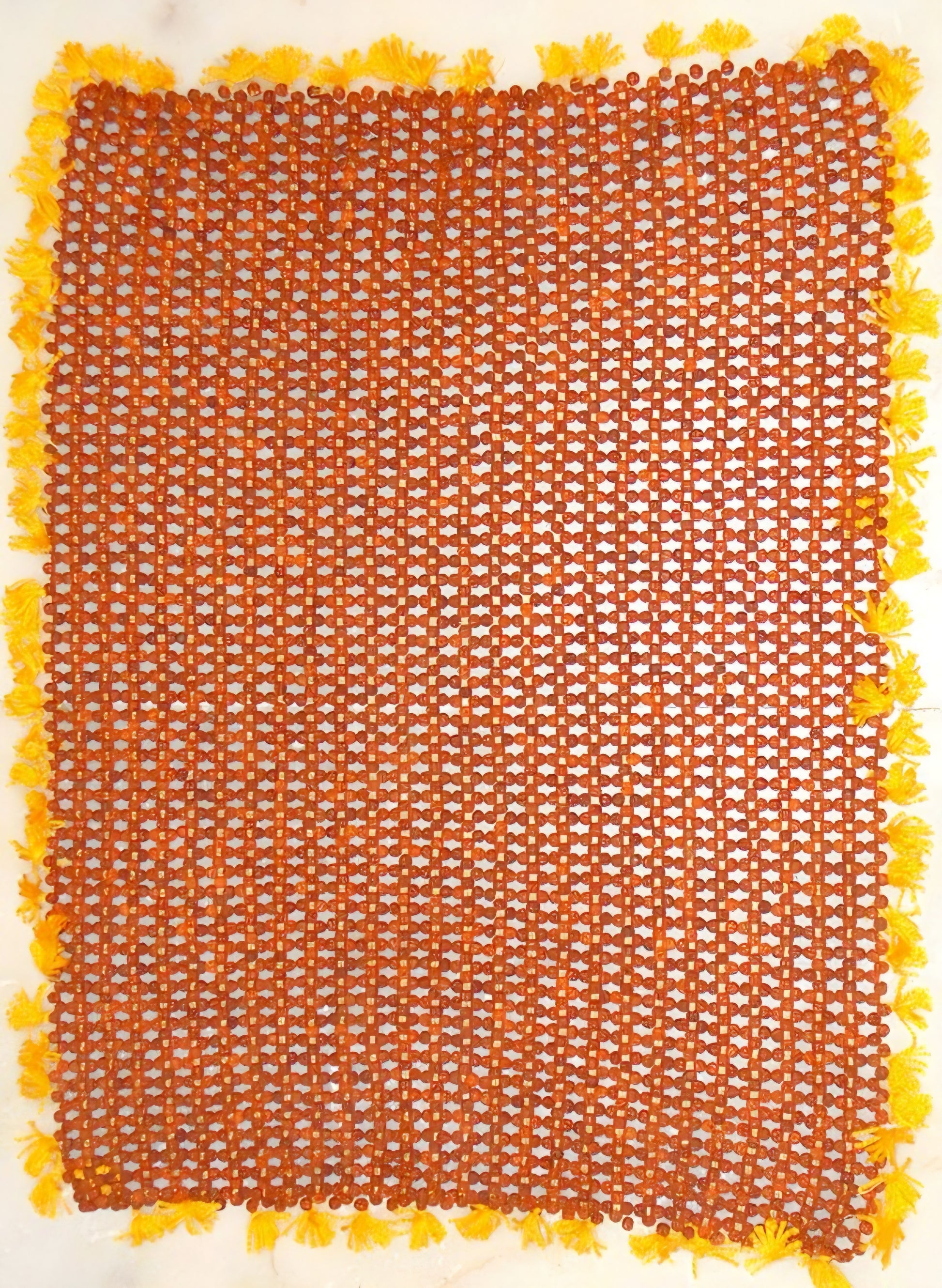 Square orange rudraksha bead seating mat with yellow tassel border