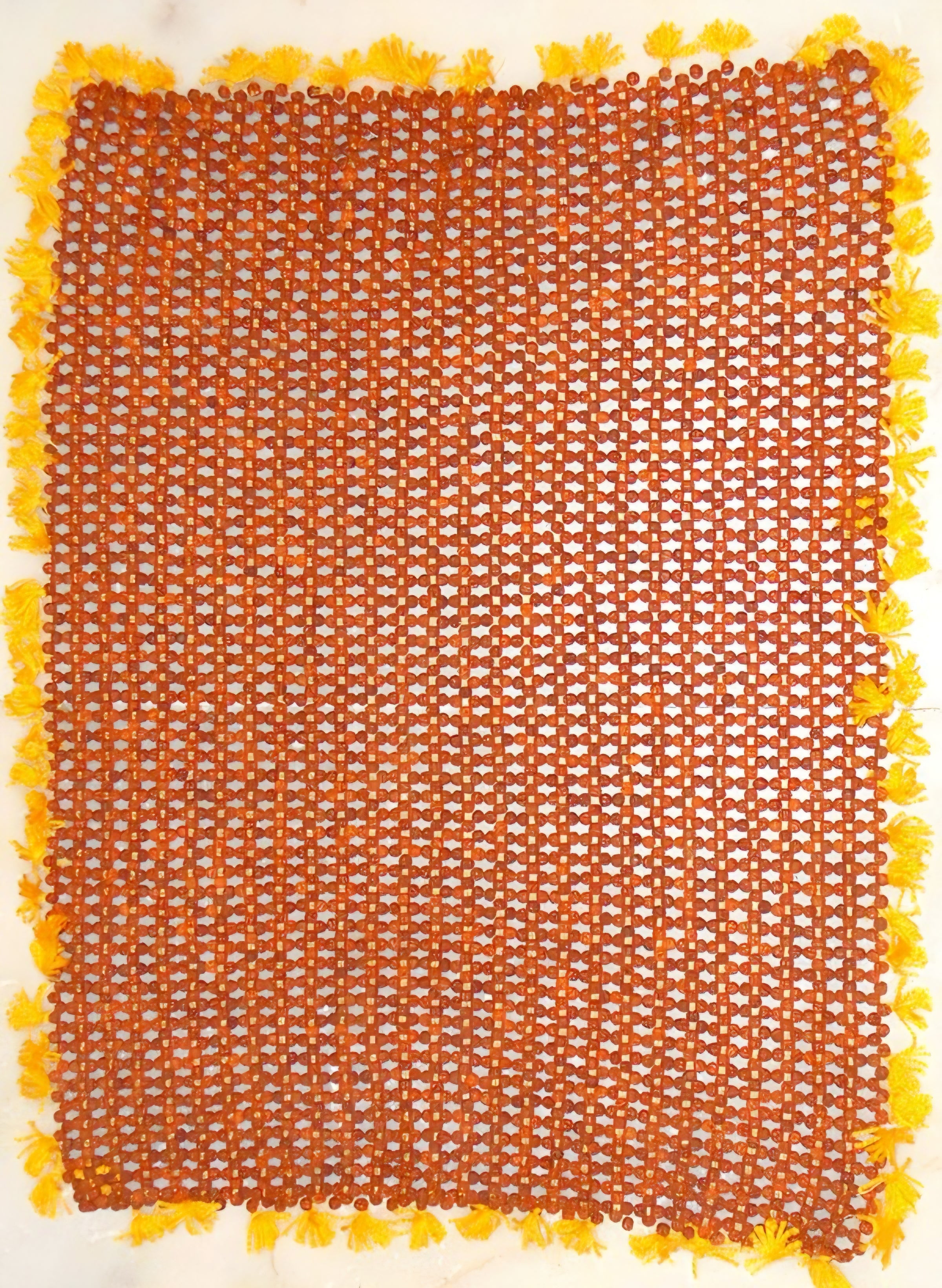 Square orange rudraksha bead seating mat with yellow tassel border