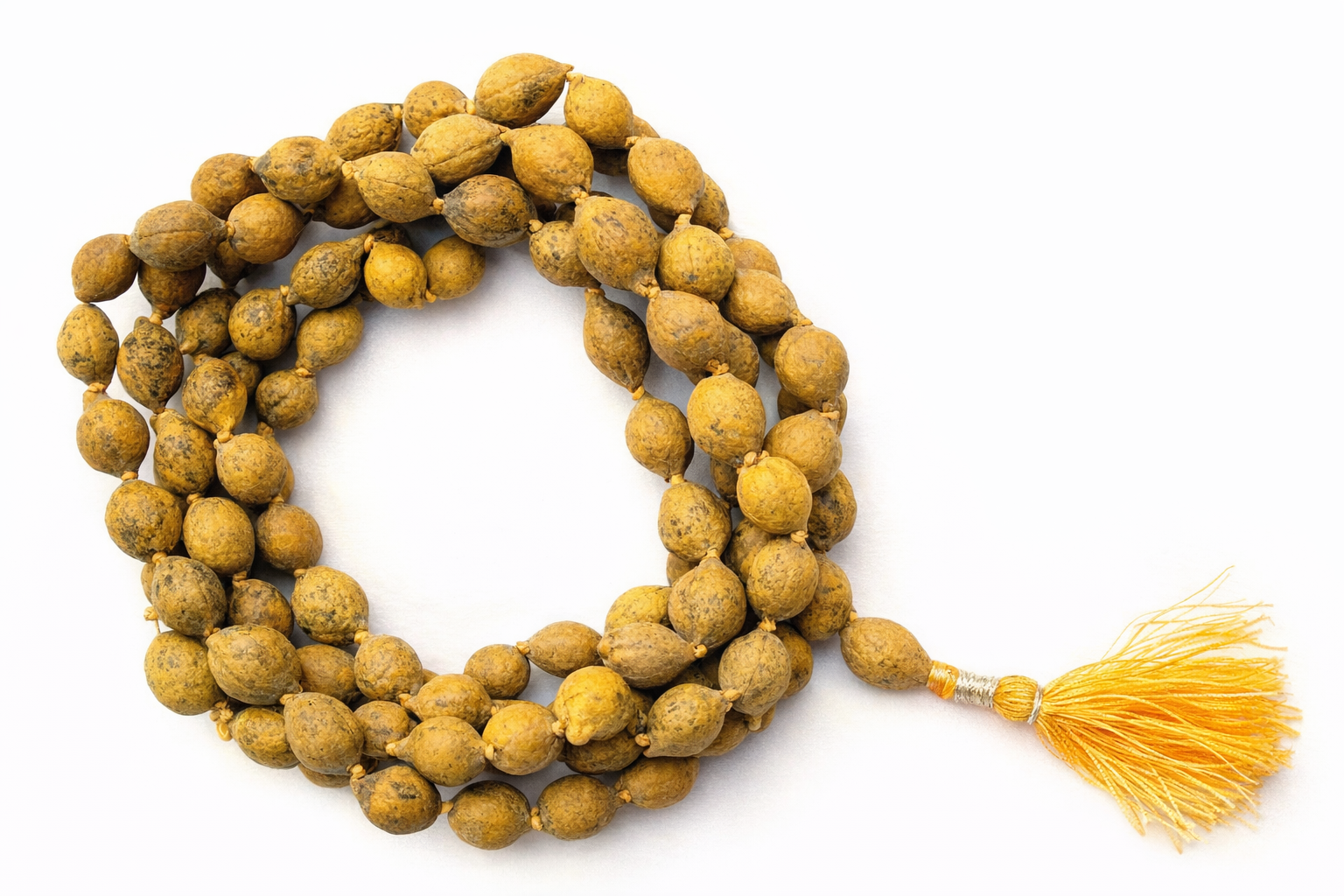 Traditional seed mala rosary with golden-brown beads and bright orange tassel
