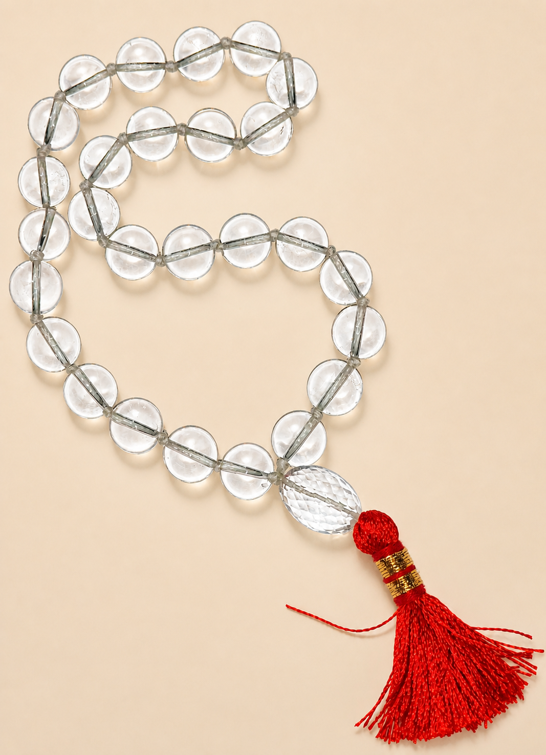 Two loops of clear quartz bead wrist mala with oval Sumeru bead and red tassel