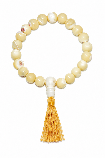 Round mother-of-pearl bead stretch bracelet with gold tassel, cream and white