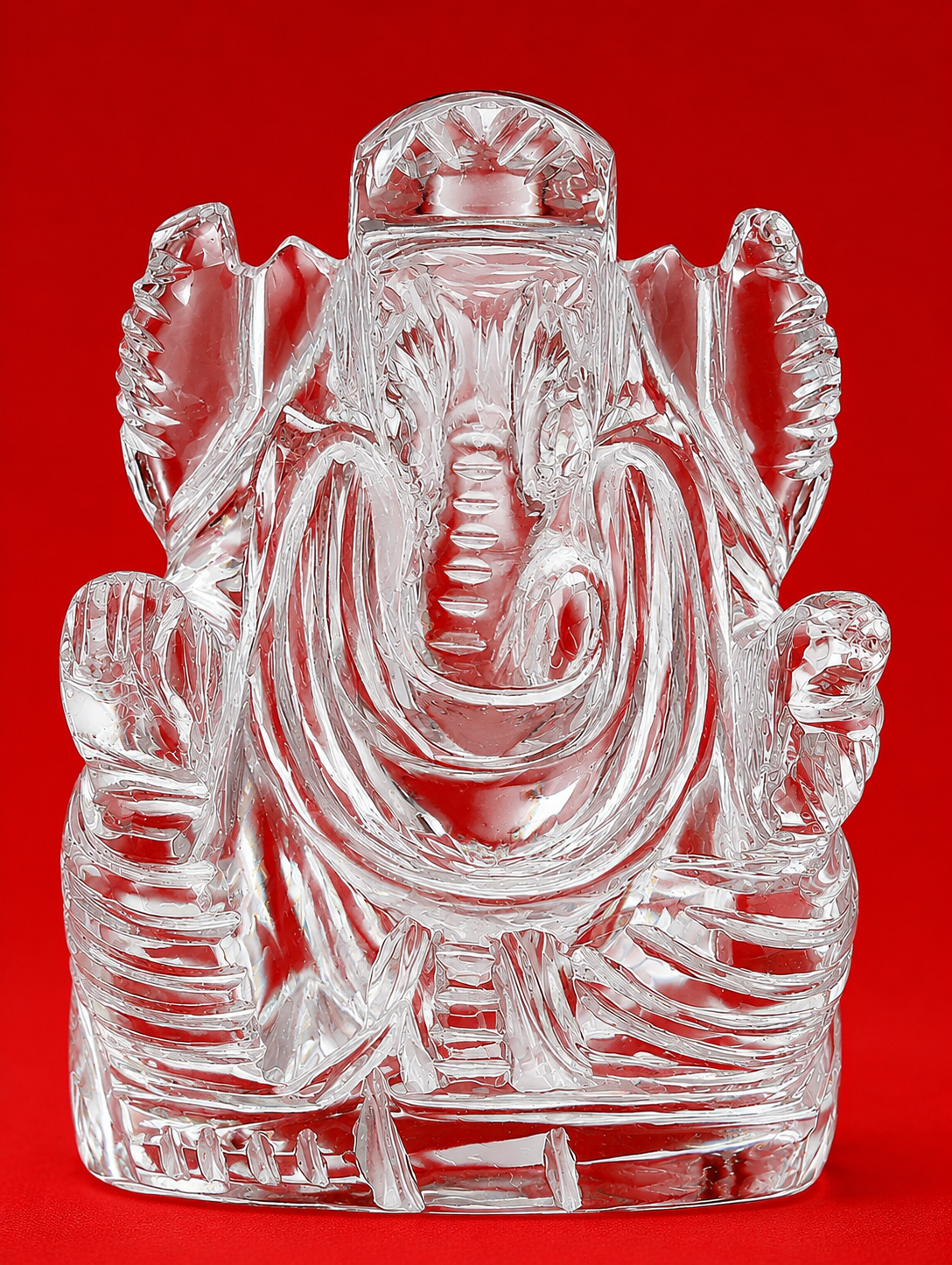 Clear crystal Ganesha statue with raised trunk and outstretched hands, glossy finish