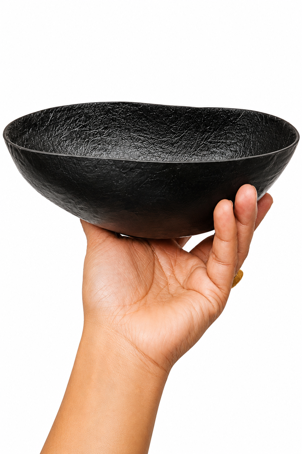 Black textured khappar bowl held near rim by hand, shallow wide dish