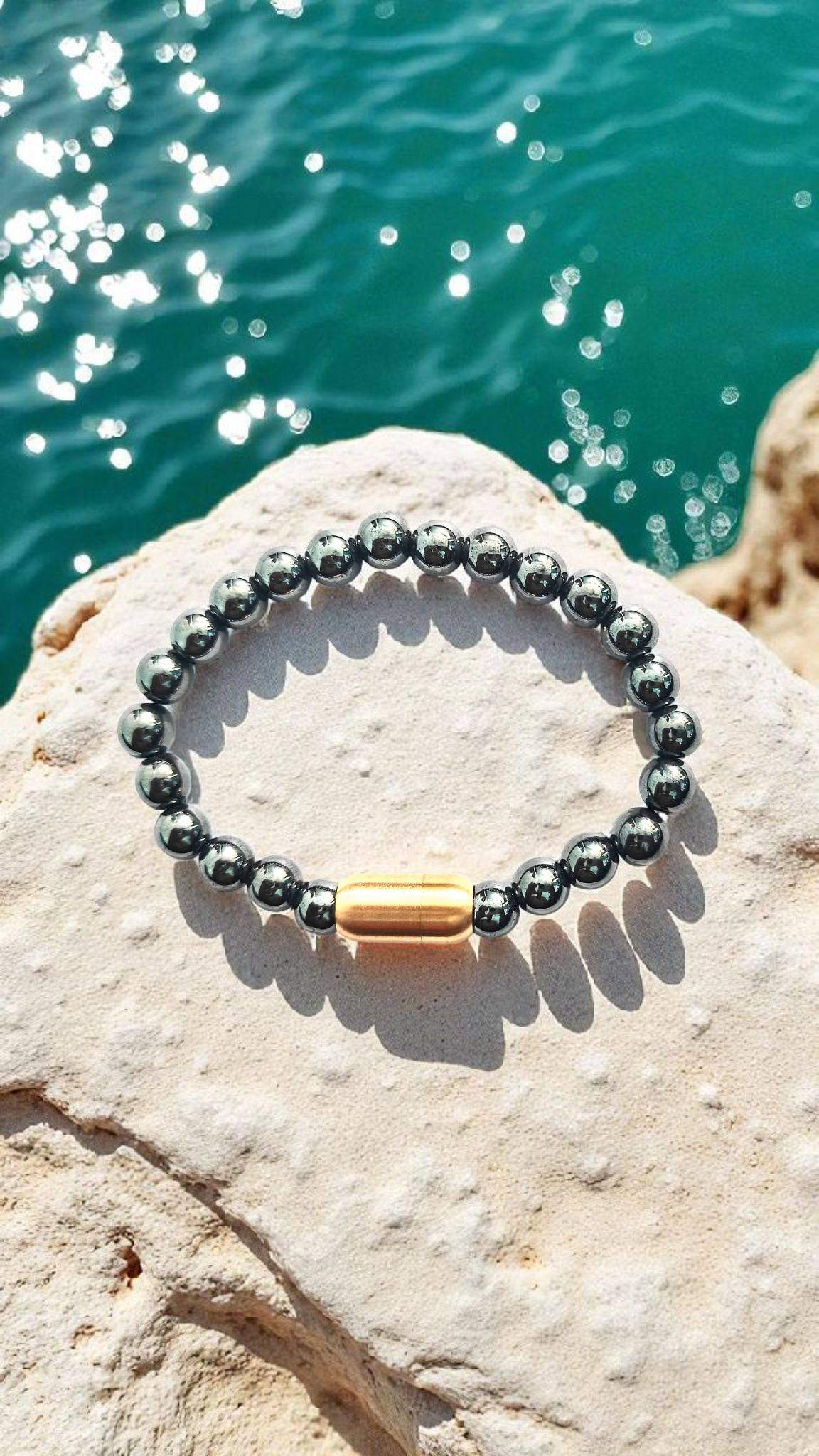 Hematite bead bracelet with magnetic clasp and copper center bar