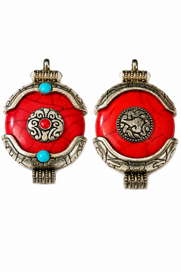 Close-up of red crackle resin Ghau charm pendant with silver-tone caps and turquoise beads