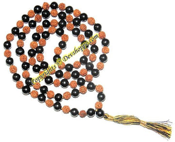 Black and rudraksha bead mala with orange carved beads and gold tassel
